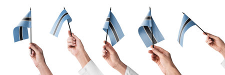 The Botswana flag in hand in different angles on a white backgroundの写真素材