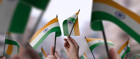 India flags in their hands on a blurred urban backgroundの写真素材