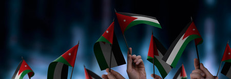 Jordan flags in their hands on a blurred urban backgroundの写真素材