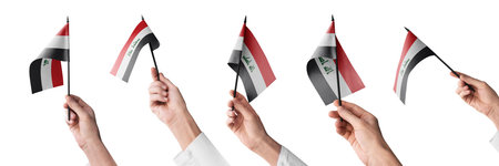 The Iraq flag in hand in different angles on a white backgroundの写真素材