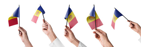 The Andorra flag in hand in different angles on a white backgroundの写真素材