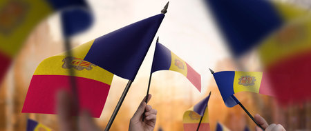 Andorra flags in their hands on a blurred urban backgroundの写真素材