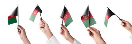 The Afghanistan flag in hand in different angles on a white backgroundの写真素材