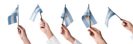The Argentina flag in hand in different angles on a white backgroundの写真素材