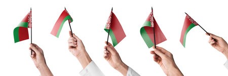 The Belarus flag in hand in different angles on a white backgroundの写真素材
