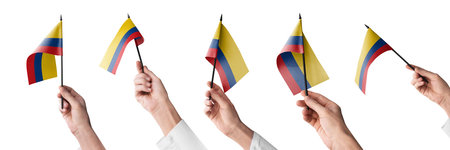 The Colombia flag in hand in different angles on a white backgroundの写真素材
