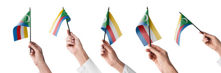 The Comoros flag in hand in different angles on a white backgroundの写真素材