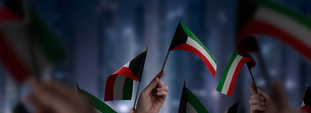 Kuwait flags in their hands on a blurred urban background