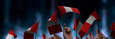 Peru flags in their hands on a blurred urban background