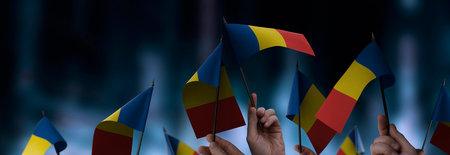 Romania flags in their hands on a blurred urban background