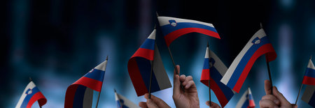 Slovenia flags in their hands on a blurred urban background