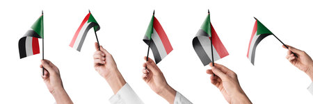 The Sudan flag in hand in different angles on a white background