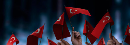 Turkey flags in their hands on a blurred urban background