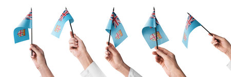 The Fiji flag in hand in different angles on a white background