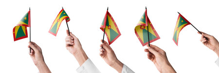 The Grenada flag in hand in different angles on a white backgroundの写真素材