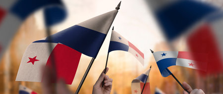 Panama flags in their hands on a blurred urban backgroundの写真素材