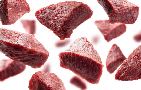 Pieces of fresh meat levitate on a white backgroundの写真素材