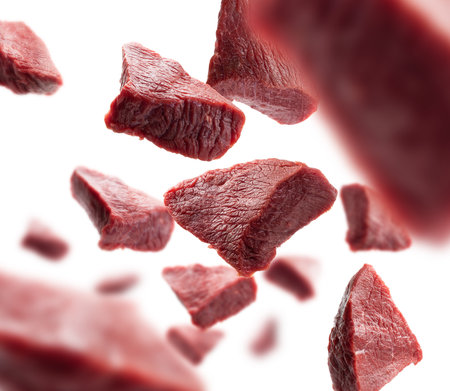 Pieces of fresh meat levitate on a white backgroundの写真素材