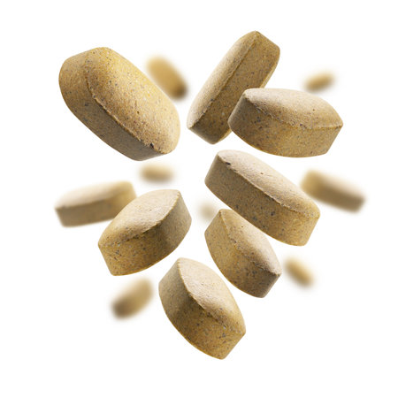 Yellow tablets levitate on a white backgroundの写真素材