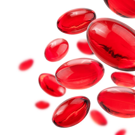 Red capsules levitate on a white backgroundの写真素材