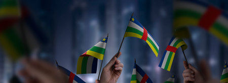 Central African Republic flags in their hands on a blurred urban backgroundの写真素材