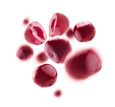 Red cherry berries levitate on a white background
