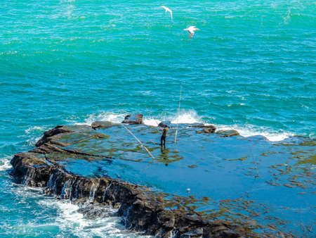 Fishing at Maukatia (Maori Bay) and Muriwai Beach. Auckland, New Zealandの写真素材