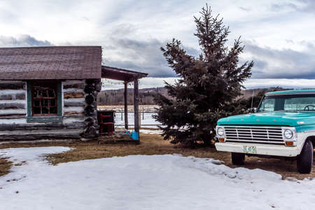 Rustic log cabin and vintage auto, Millarville, Alberta, Canadaのeditorial素材