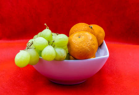 Colourful fruit in a white bowl against a colouful back drop. Calgary, Alberta, Canadaの写真素材