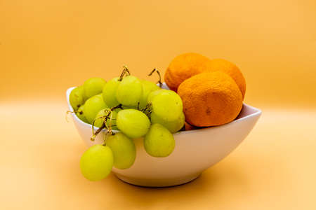 Colourful fruit in a white bowl against a colouful back drop. Calgary, Alberta, Canadaの写真素材
