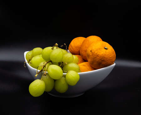 Colourful fruit in a white bowl against a colouful back drop. Calgary, Alberta, Canadaの写真素材