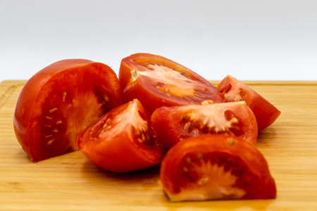 Red tomatoes on a wooden cutting board. Calgary, Alberta, Canada