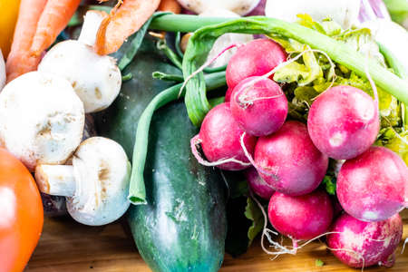 Colourful assorted raw vegetables on a wooden cutting board. Calgary, Alberta, Canadaの写真素材