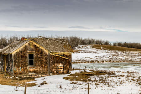 Abonded homes and homesteads dot the landscape. Alberta, Canadaの写真素材