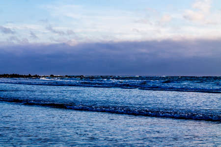 Surf rolling in on Opunaki Beach. Opunaki, New Zealandの写真素材