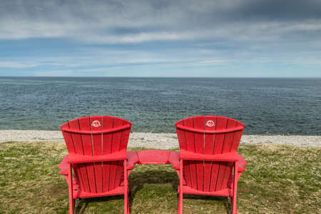 Red chairs overlooking the St Lawrence from Vessels Brook River. Gros Morne National Park, Newfoundland, Canadaの写真素材