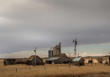 Rustic fam buildings sit on the prairies Vulcan County Alberta Canadaの写真素材