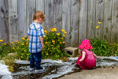 Children helping with washing the car, playing in the water and getting all sudsy. Taranaki, New...