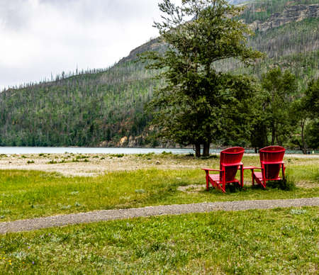 Red Chairs Cameron Creek Waterton Lakes National Park Alberta Canadaの写真素材