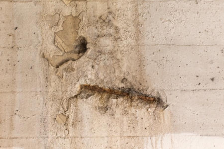 Texture detail of metal revealed on white concrete wallの写真素材