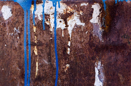 Blue and white paint spill on rusted metal textureの写真素材