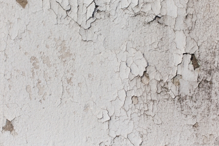 white paint peeling away from concrete pillarの写真素材