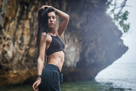 Brunette girl with beautiful face and grate body on the Bali beach