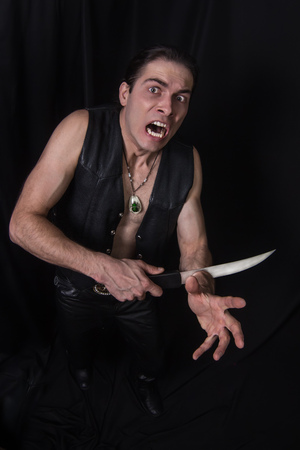 The man cuting him arm a big knifeの写真素材