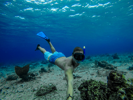 Underwater wide angle selfie of muscular swimmer with a lot of bulbの写真素材