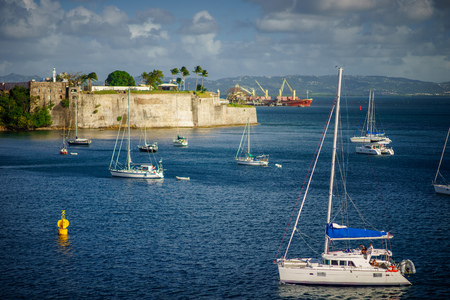 Luxury yachts anchored in the blue water with fort on backgroundの写真素材