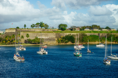 Luxury yachts anchored in the blue water with fort on backgroundの写真素材