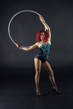 beautiful female red hair circus artist with a hoopの写真素材