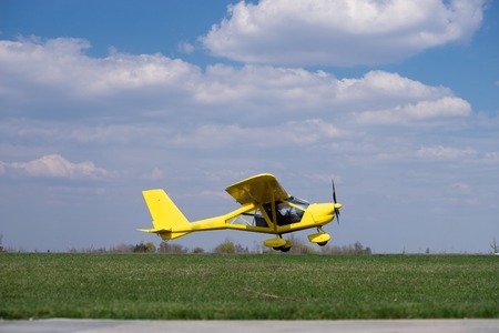 Small Plane Taking Off from green field. Concept of increase and developmentの写真素材