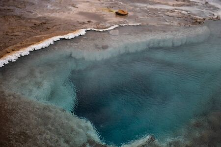 Blue pool of hot spring in geothermal zone close to famous Geyser in Iceland